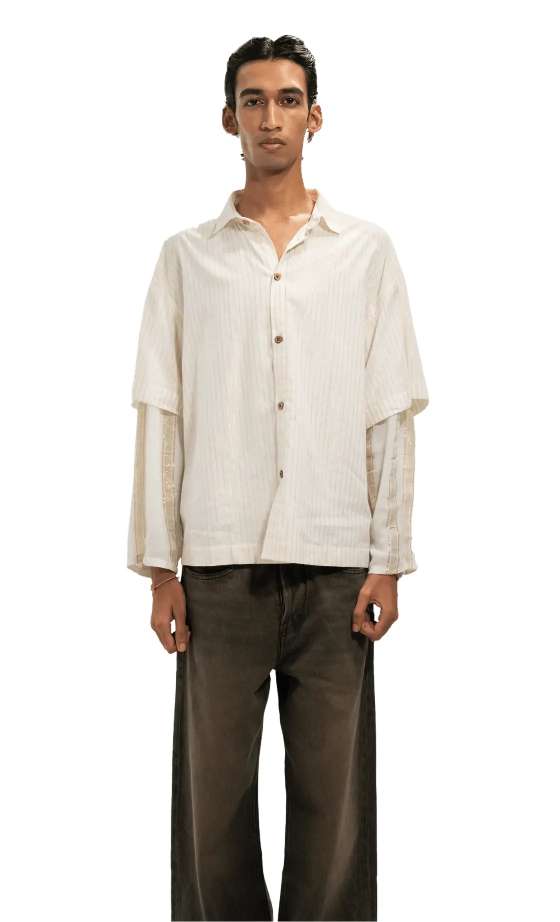 Man wearing a light-colored shirt and dark pants on a white background