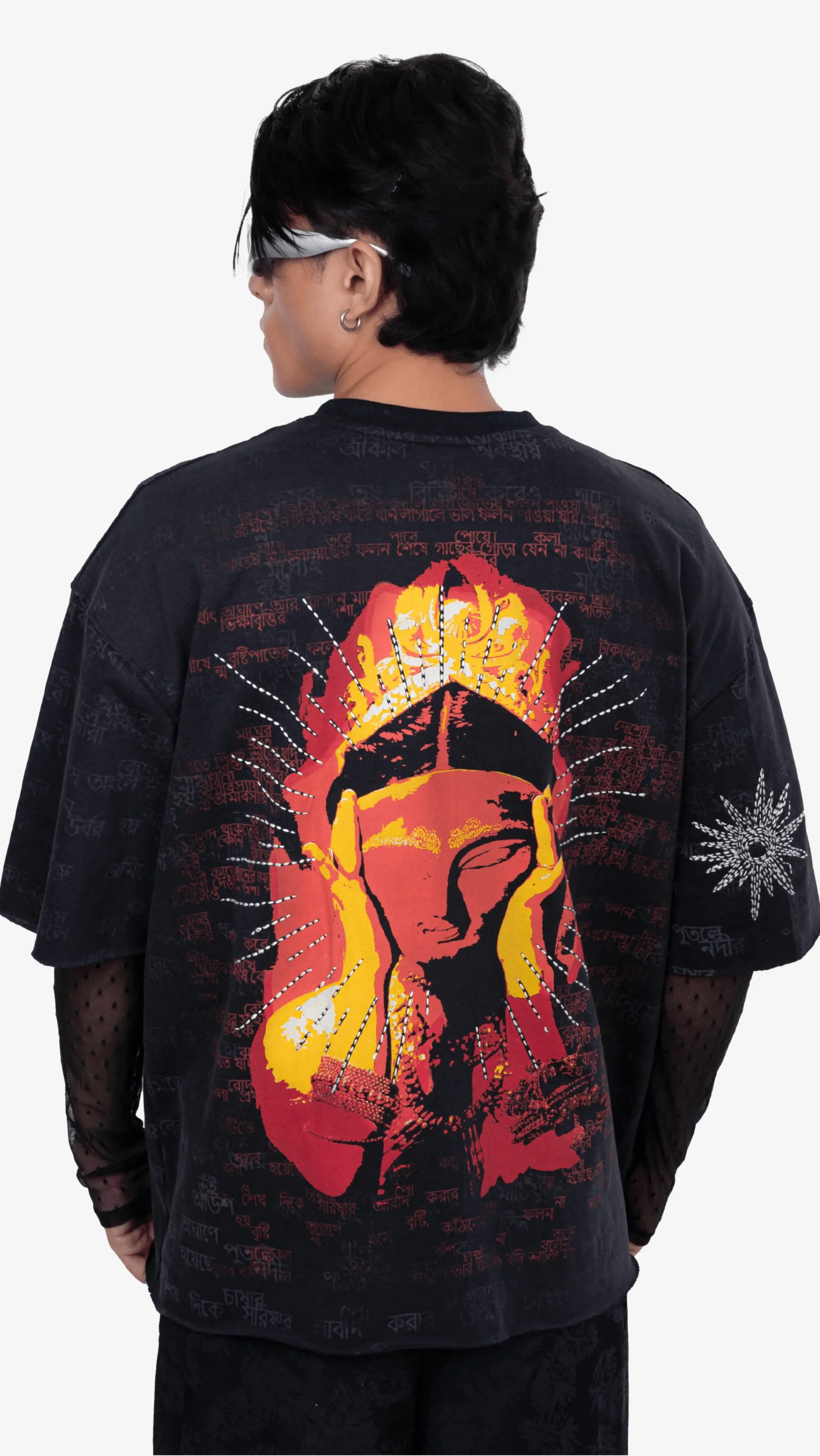 Black Sattva & Sage t-shirt with a vibrant back graphic featuring a stylized crowned face, worn by a model.