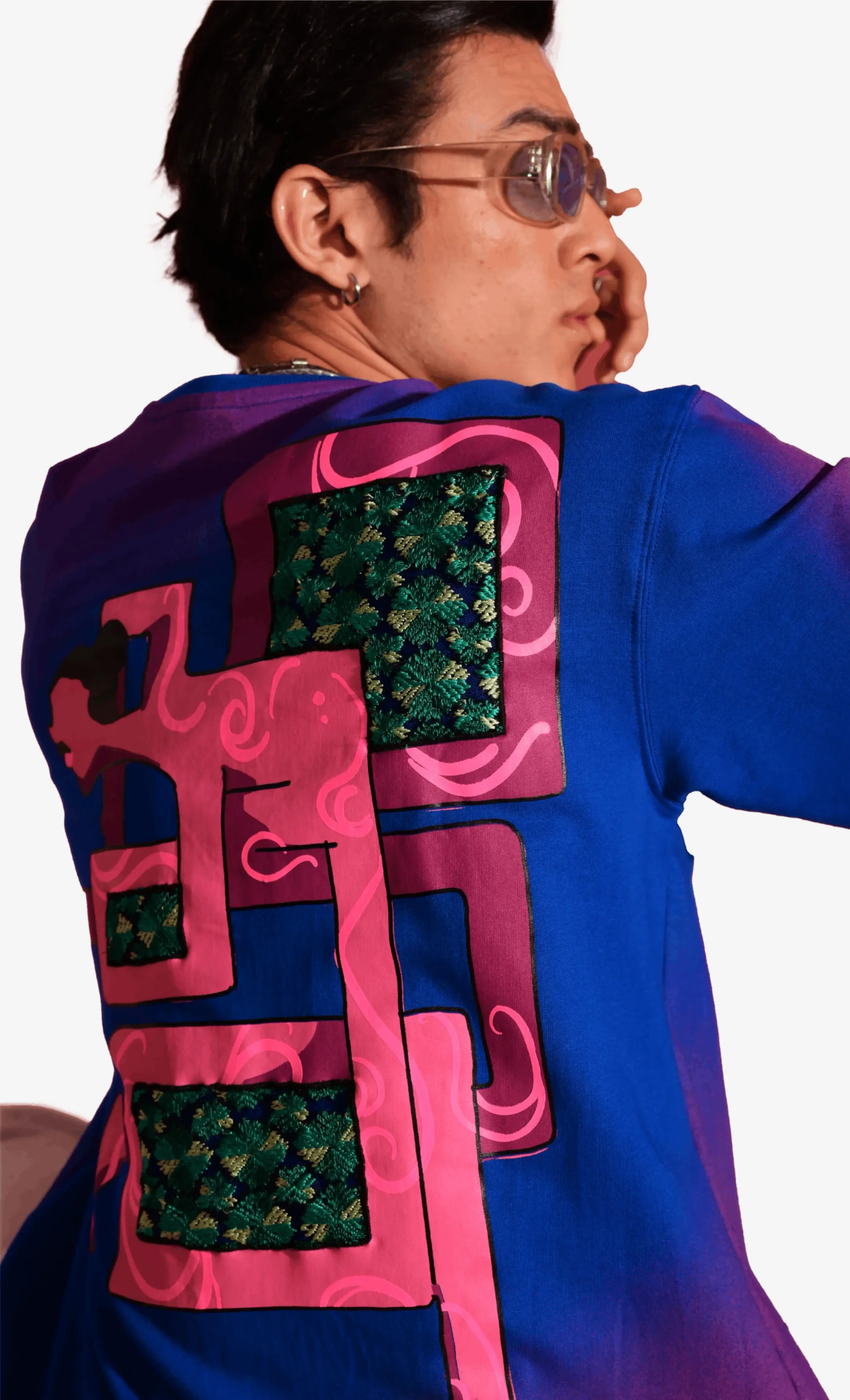 Person wearing a colorful Sattva and Sage jacket with abstract patterns on a white background.