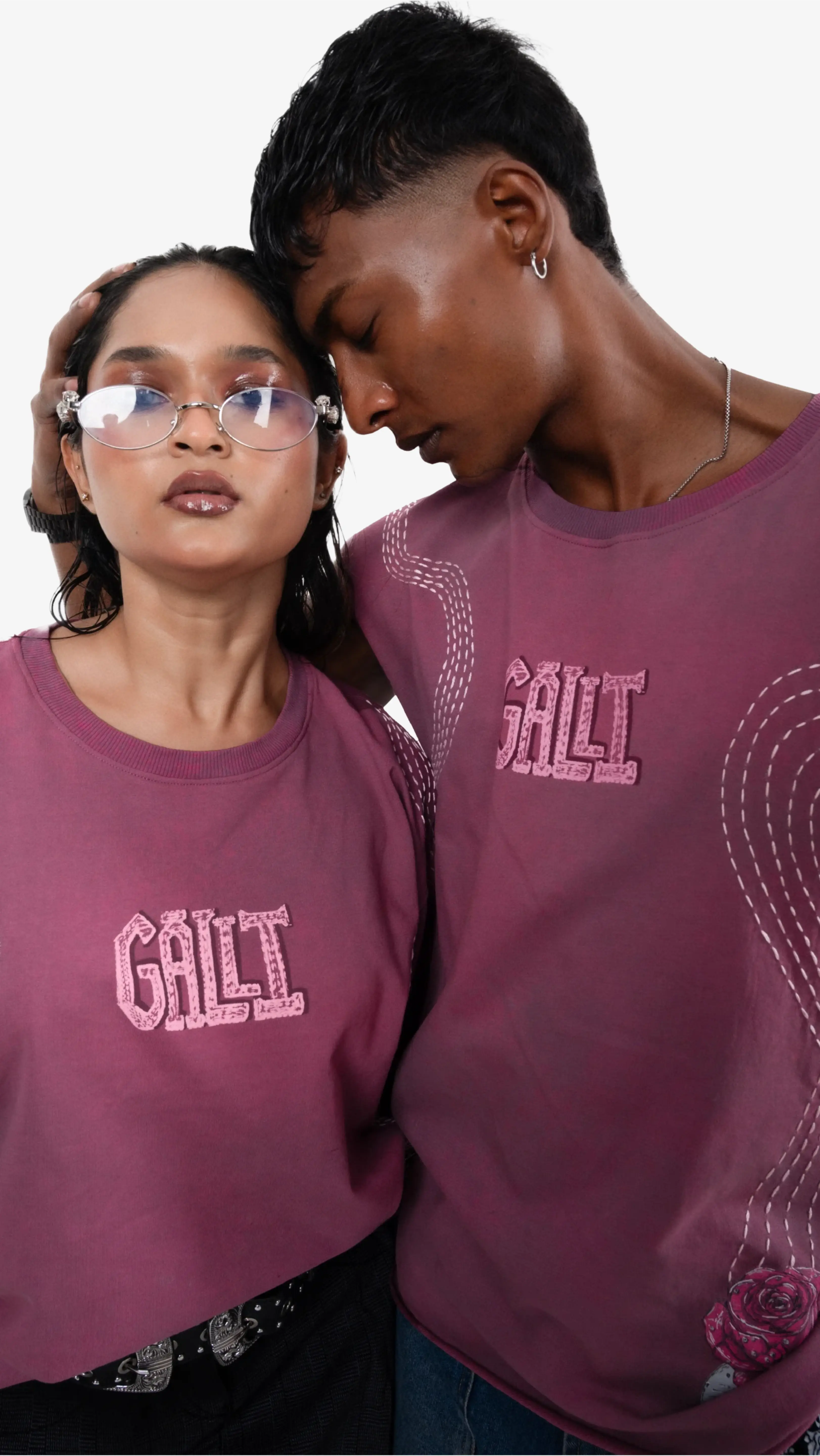 Two people wearing maroon 'Galli' t-shirts against a white background