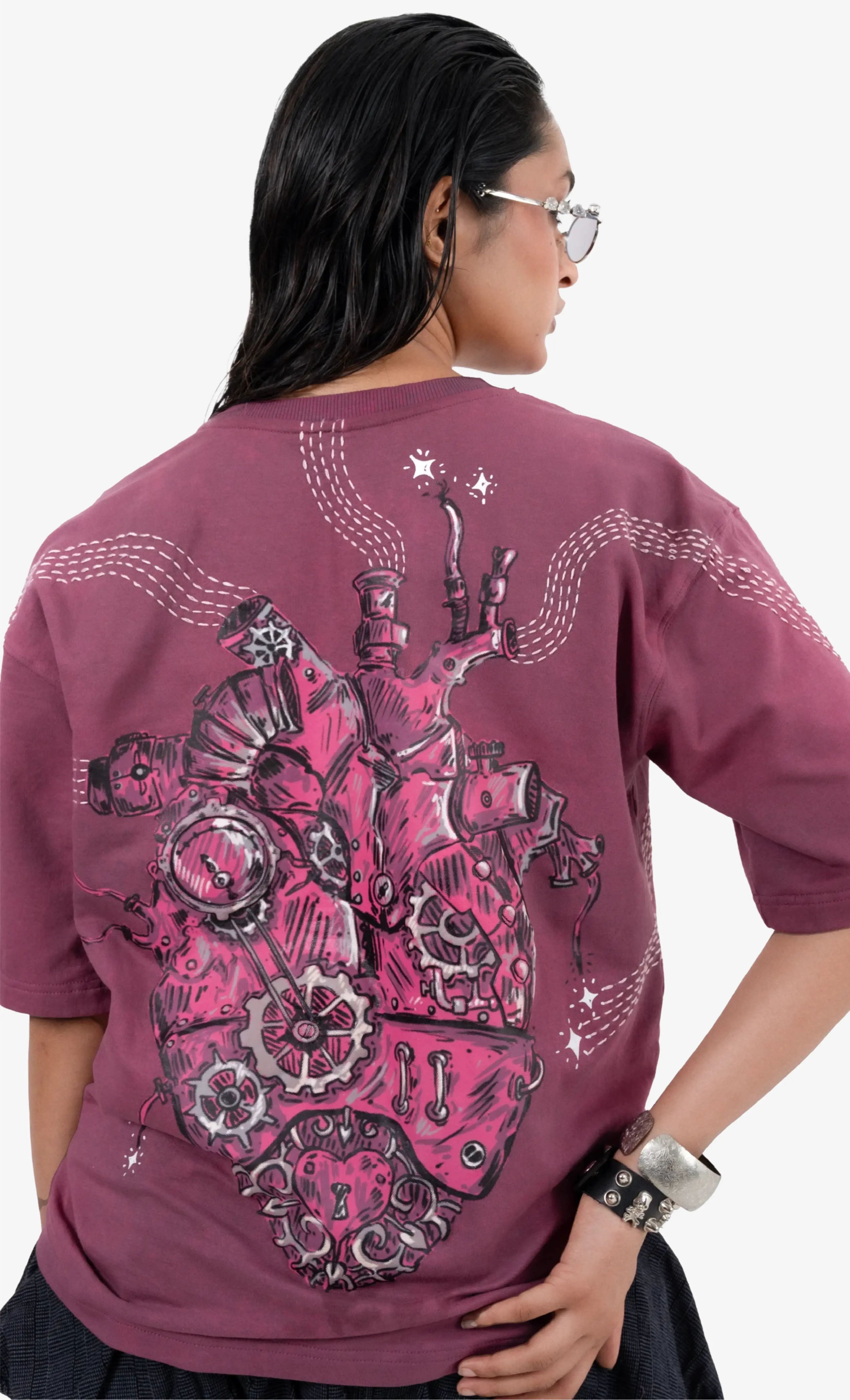 Person wearing a purple t-shirt with a robot design on the back, standing against a white background.