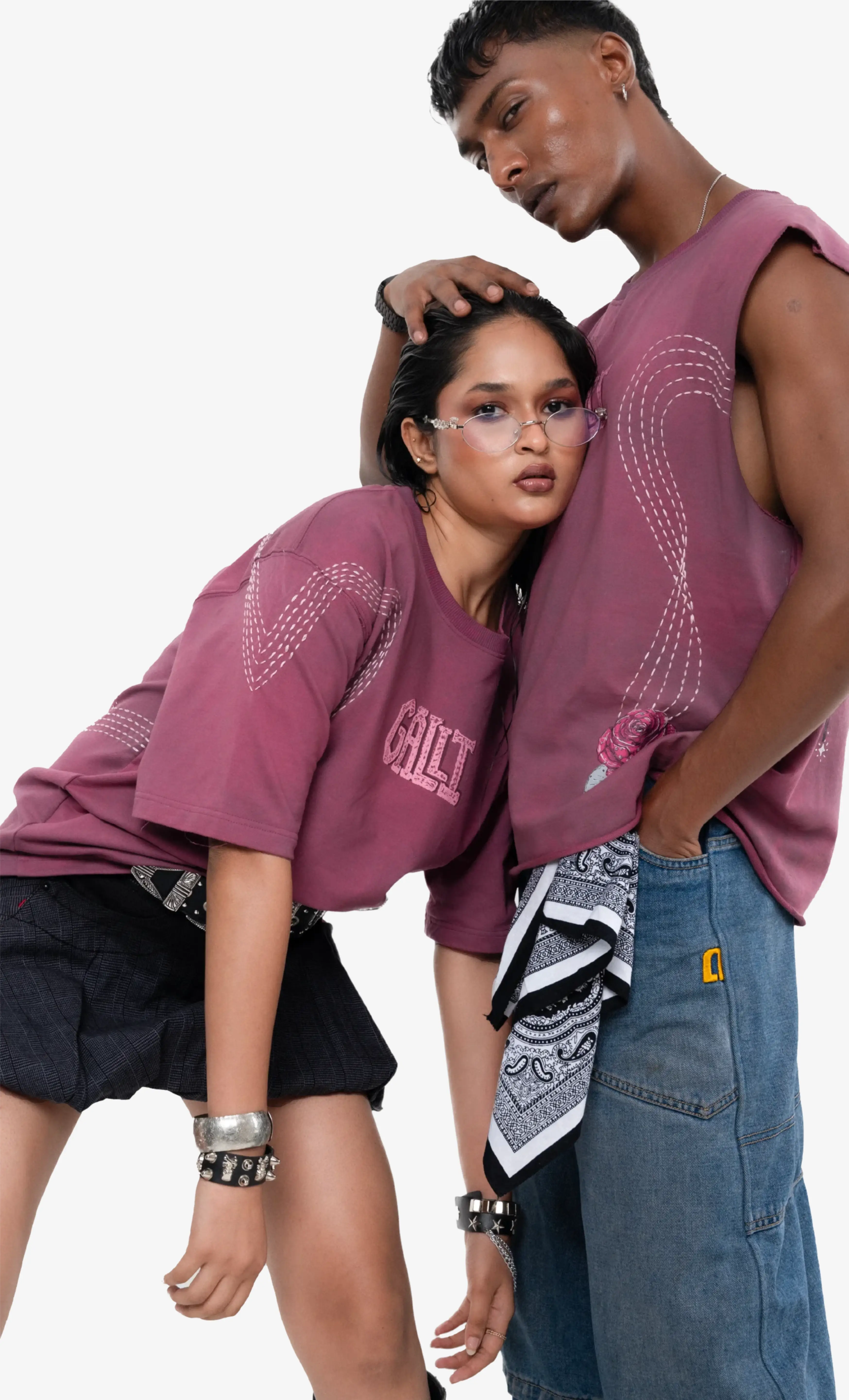 Two people wearing matching maroon t-shirts on a white background