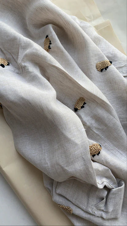 Black sheep shirt on beige linen