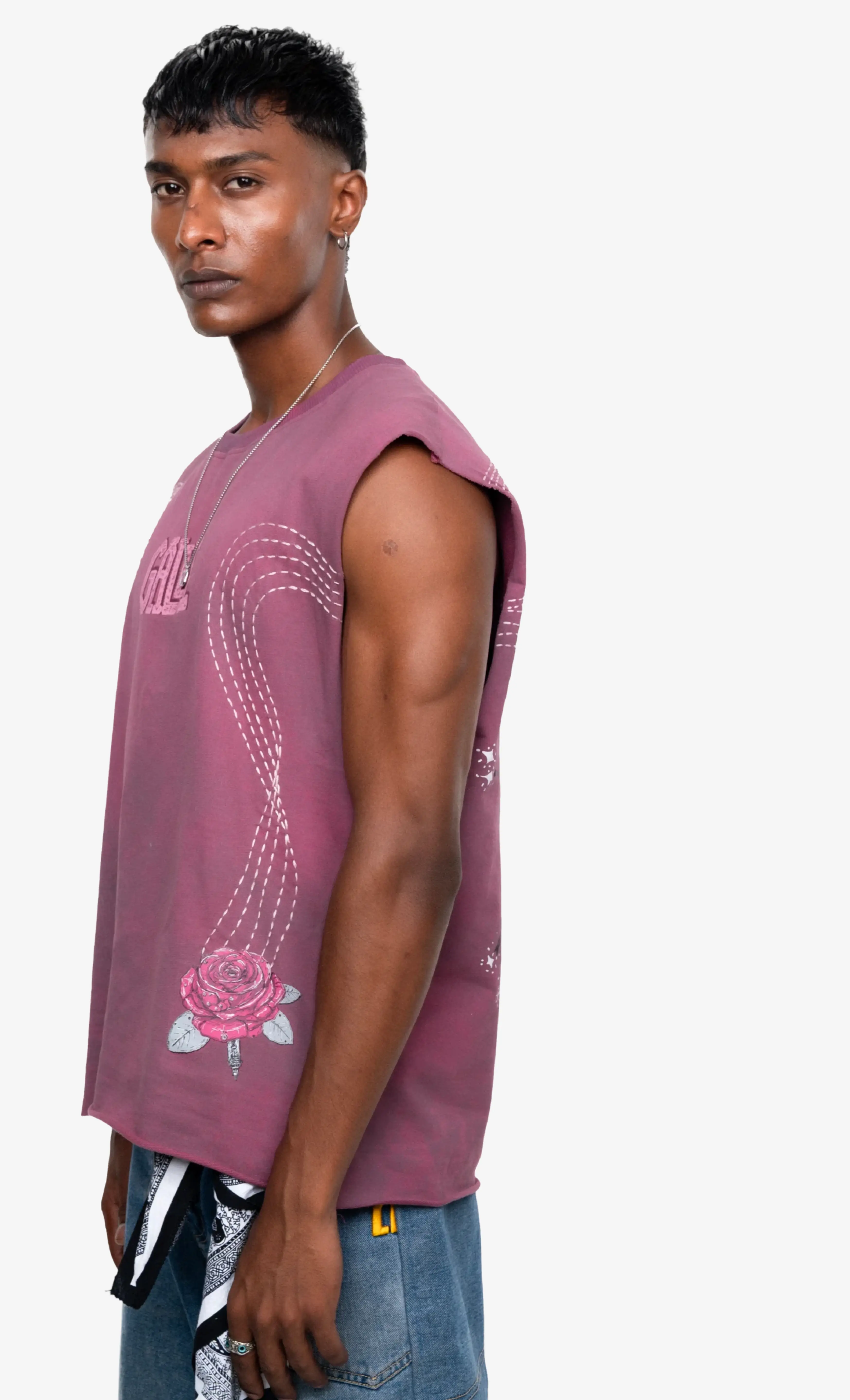 Man wearing a maroon sleeveless shirt with a floral design on a white background